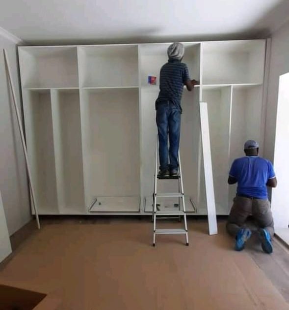 CDC Projects team installing wall-to-wall cupboards in a Cape Town home