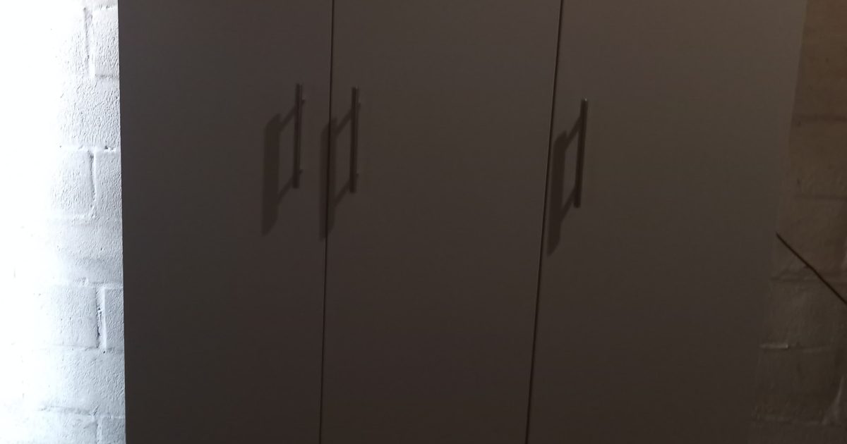 Free-standing three-door melamine cupboard built by CDC Projects