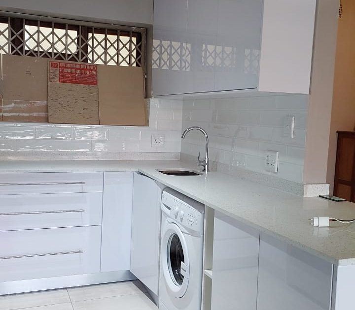 Fitted kitchen cupboards with washing machine space in a Cape Town kitchen